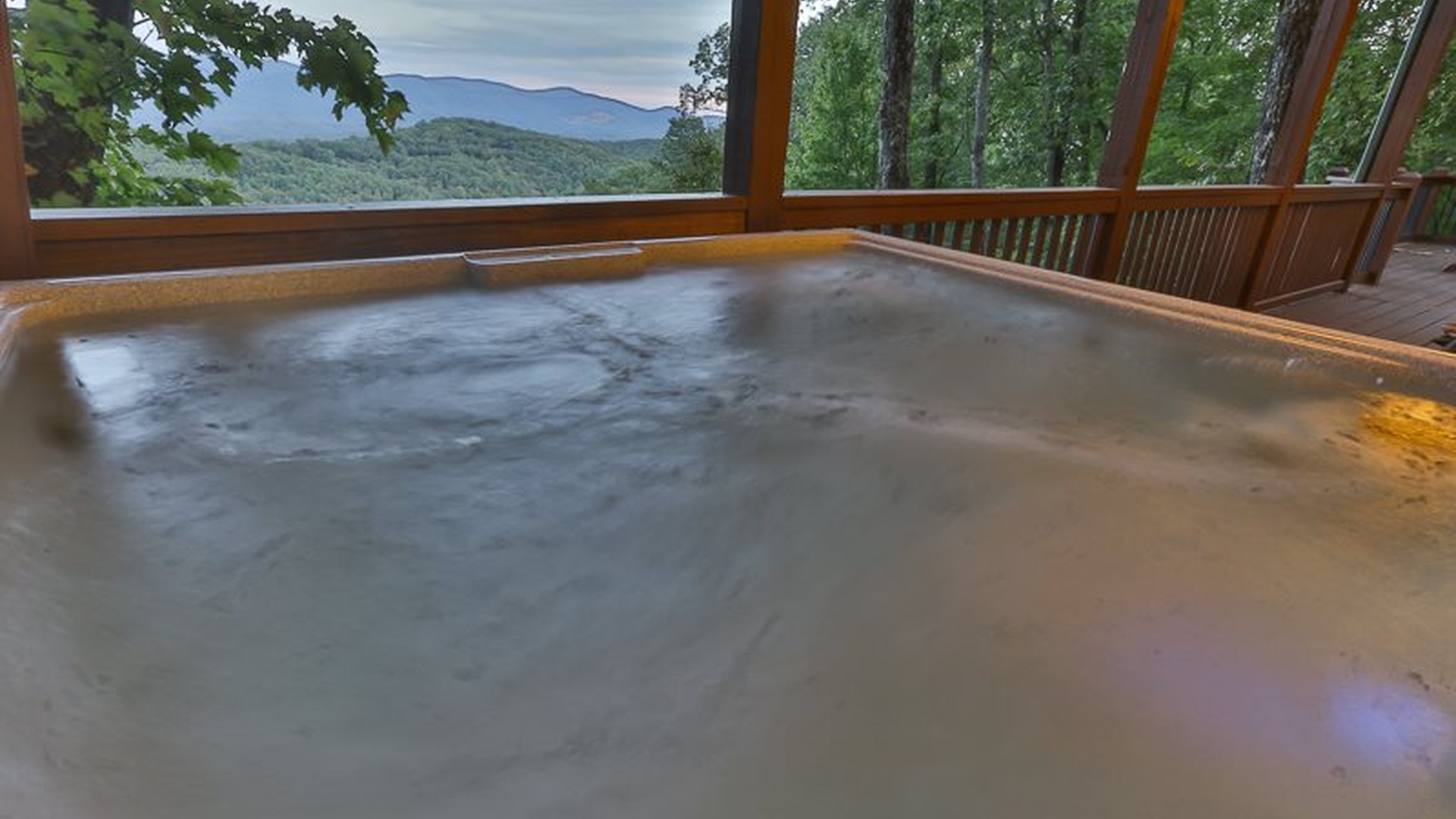 Covered hot tub with mountain views — the correct answer after a long day.